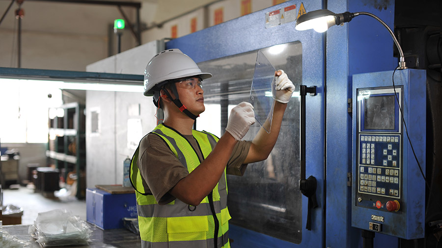 Workers are injection molding license plate frames